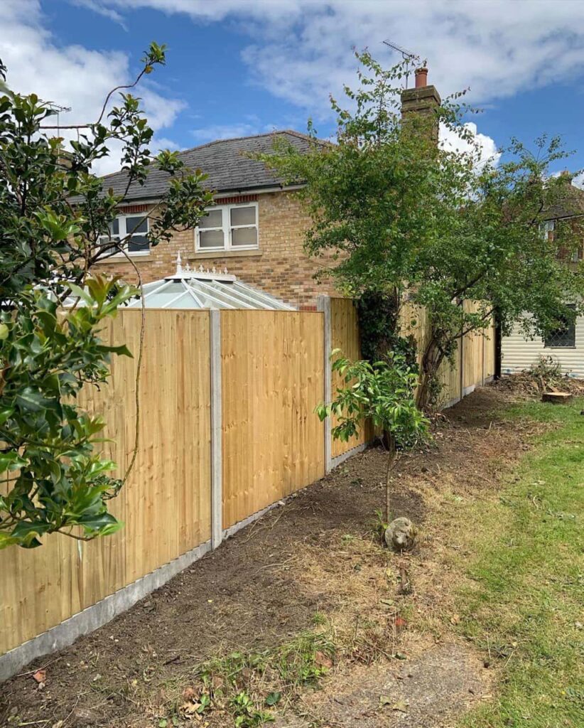 This is a photo of fence panels installed in a residential garden using concrete posts and gravel boards. Installed by Fast Fix Fencing Swaffham